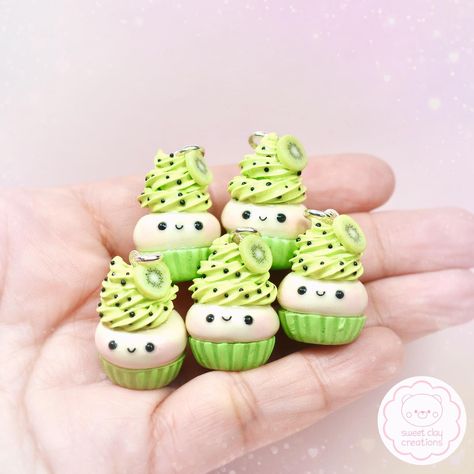 Kiwi Kawaii Cupcake Charms! 🥝🧁#kiwi #kiwicupcakes #kawaiicupcake #kawaiicharm #kawaiijewelry #kawaiiaccessories #charm #cupcakes #polymerclay #clay #polymerckayjewelry #fimo #sculpey #handmade #handmadecharms #handmadejewelry #minifood #miniaturefood #miniaturefoodjewelry #kawaiifood #kawaiifoodjewelry #sweetclaycreations #cute #onlineshop #giftideas Clay Shelf, Craft Miniature, Kawaii Cups, Charm Ideas, Gingerbread Decor, Christmas Nutcrackers, Clay Inspo, Miniature Clay, Cupcake Charms