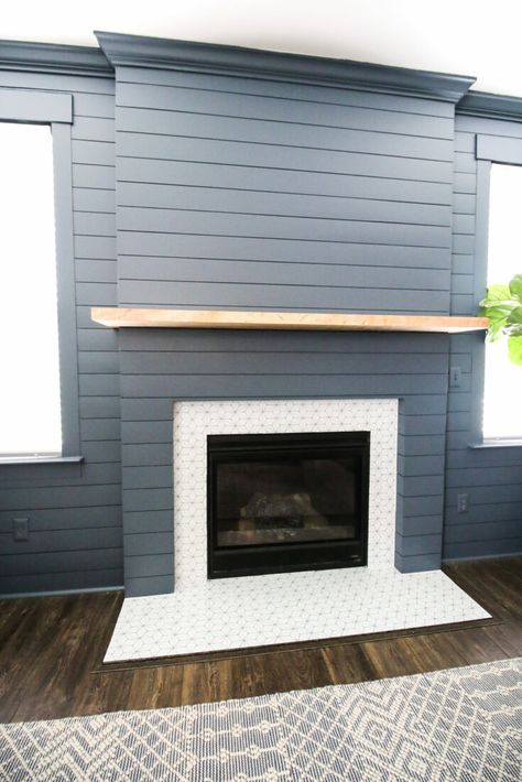 This started out as a flat gas fireplace insert with a traditional mantle and surround, and now it's a modern farmhouse beauty.Building a frame to bump out the fireplace gives it more presence in the room, turning it into the focal point of the space without having to spend a lot of money to do it. Love the addition of the ceramic tile around the insert and on the hearth too. The tile and color of the shiplap along with the fireplace mantle give this fireplace remodel a lovely coastal vibe. Diy Shiplap Fireplace, Painting Shiplap, Granite Fireplace, Installing Shiplap, Fireplace Update, Build A Fireplace, White Shiplap Wall, Shiplap Fireplace, Shiplap Accent Wall