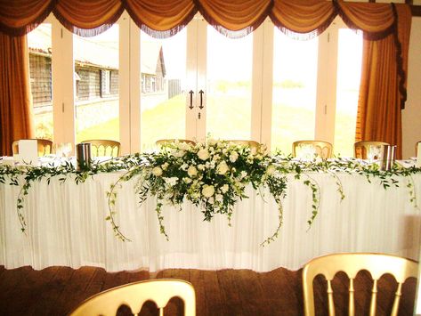 Long and low top table arrangement, wedding, ivory, trailing ivy, white Naomi rose, stocks, antirrhinum, hard ruscus. Long And Low Arrangement, Table Arrangement Wedding, Top Table Arrangement, Shower Bouquet, Grey Wedding, Table Arrangement, Gray Weddings, Top Table, Wedding Business