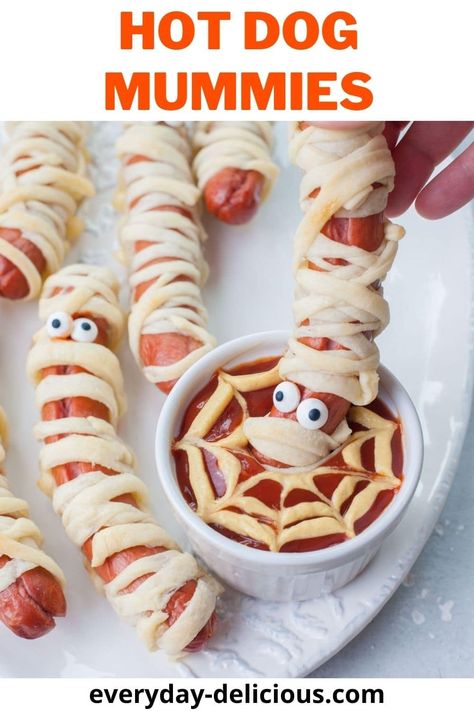 These mummy hot dogs are delicious and easy savory Halloween snack. Just wrap pizza dough around some hot dogs and bake! (you can also use crescent dough). Kids will love this fun twist on the classic pigs in a blanket. Serve them with spider's web ketchup-mustard dip. Halloween Chocolate Covered Strawberries, Wrap Pizza, Pumpkin Cranberry Muffins, Mummy Hot Dogs, Hot Dog Pizza, Honey Mustard Dip, Mummy Recipes, Mummy Dogs, Mustard Dip