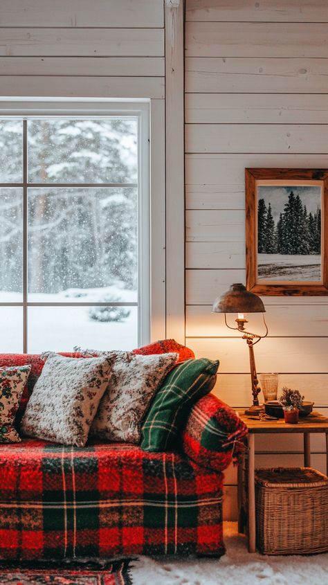 Cozy rustic living room with a plaid couch, warm lighting, and snowy winter view outside the window. Scottish Interior Design, Scottish Living Room, Scottish Cottage Interior, Scottish Home Decor, Plaid Couch, Cozy Farmhouse Christmas, Scottish Interiors, Scottish Cottages, Farmhouse Christmas Decor Ideas