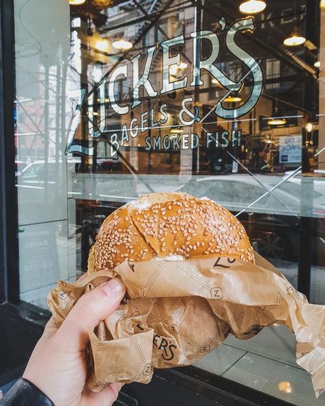 Hand holding cream cheese sesame seed bagel outside shop window | 15 Awesome and Affordable Places to Eat in New York City | NYC cheap eats | Breakfast in New York | Lunch in New York | New York Desserts | New York, USA, city guide New York Bagel Shop, Bagel New York, Breakfast New York, Best Bagels In Nyc, Nyc Bagels, New York Desserts, Bagels Nyc, New York Bagels, Eat In New York City