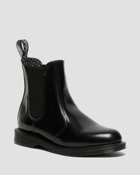 The Flora chelsea boot in polished black smooth leather. The elastic gusset allows slip on ease and pin dot lining adds an interesting final touch to these durable boots. Flora boots are heat-sealed then stitched and the plain welted sole has no visible construction thread. Care Instructions: Clean away dirt using a damp cloth, allow to dry and apply a correctly coloured wax based shoe polish to restore shine. Upper: 70% Leather, 30% Elastic Lining: 100% Textile Sole: 100% PVC Dr Martens Flora, Dr Martens Chelsea Boots, Dr Martens Chelsea, Chelsea Boots Style, Black And White Heels, Random Fashion, Botas Chelsea, Boot Style, Black Polish