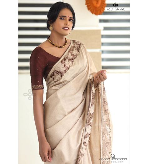 #Repost
///@rutwva_insta: M.A.P.L.E 🍁
.
Simple beige brown saree with cutwork detail on borders.

These cutworked borders are highlighted with handembroidery in cutbeads and beads.

This look is completed by pairing it with a burnt coffee pure rawsilk blouse with handembroidered sleeves.
.
Drop a message or contact on 9207675346/8848874044 for orders and enquiries.

Muse : @gourry_bhadhraas 
Photography : @anoopupaasana_photography 
MUA : @parinayah @rabisruthy 
Outfit&styling : @rutwva_insta Cream Colour Saree Blouse Combination, Coffee Brown Blouse Designs, Brown Saree With Contrast Blouse, Beige Saree With Contrast Blouse, Brown Saree Combination Blouse, Coffee Brown Saree Combination Blouse, Brown Blouse Designs For Saree, Coffee Brown Saree, Blouse Designing