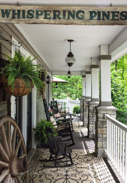 A consistent color scheme with a heavy dose of patterns mixed in helps to give the entire porch a more cohesive feel. White accents, including the paneled ceiling and fencing, help brighten the space up. Country Front Porches, Above Rubies, Farmhouse Porch Decor, Southern Porches, Whispering Pines, Building A Porch, Rustic Porch, Vintage Farmhouse Style, Country Porch