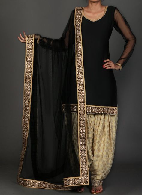 Black and Golden Brocade Punjabi Suit features a taffeta silk kameez with santoon inner, brocade salwar and net dupatta. Embroidery work is completed with lace and sequins embellishments. Punjabi Suit Color Combinations, Brocade Punjabi Suit, Suit Color Combinations, Patiala Suit Designs, Patiala Salwar Suits, Suit Styles, Punjabi Fashion, Kameez Designs, Punjabi Outfits