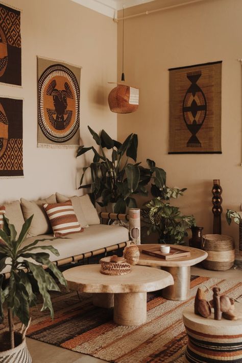 Design your living room with Afro-Bohemian decor that blends traditional African elements and modern minimalist furniture. Use natural materials and bold patterns for a stylish yet culturally rich aesthetic.#AfroBohemianDecor #ModernAfricanStyle #NaturalMaterialInteriors #MinimalistLivingRoomIdeas #AfricanInspiredDesign #BohemianLivingRoomStyle #ModernEthnicDecor African Art Decor Interior Design, Afrocentric Room Decor, African Apartment Decor, Afrocentric Apartment Decor, African Style Living Room, Afrohemian Decor Living Room, Afro Modern Decor, African Boho Living Room, Afro Chic Home Decor