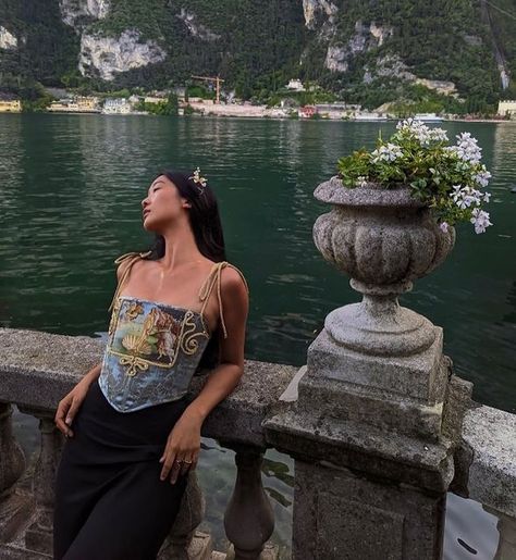 VICTORIAMISU on Instagram: "It was rather cloudy when we arrived to Riva del Garda on this Italy trip, which is what reminded of the emotion of longing. On the sidewalks it was lively, there was chatter and laughter. Yet right under swaying branches, these stone structures separated the silence upon the water of swans gliding and the voices of the land. It was like an orchestration of the swan’s lake echoing around the shore. This was on the second to last day of our stay in Italy, and of cour Lake Garda Instagram Pictures, Montenegro Outfit Ideas, Riva Del Garda Italy, Lake Garda Outfits, Lake Como Instagram Pictures, Lake Garda Aesthetic, Lake Como Instagram, Lake Como Fashion, Como Outfits