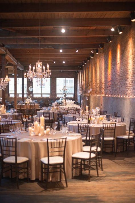 a loft with exposed brick walls and concrete is made softer with lots of candles and some glam chandeliers Chicago Decor, Wedding Venues Chicago, Chicago Lofts, Wedding Venue Ideas, Chic Wedding Venues, Bridal Aesthetic, Venue Lighting, Simple Table Settings, Michigan Wedding Venues