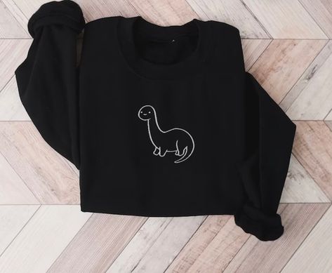 Embroidery dinosaur black sweater 🦖 #dinosaurs #embroidery #burnsyembroidery #love #cute Embroidered Dinosaur, Sweatshirts Design, Dinosaur Embroidery, Funny Sweaters, Crewneck Design, Dinosaur Design, Cute Dinosaur, Embroidered Sweatshirt, Inner Child