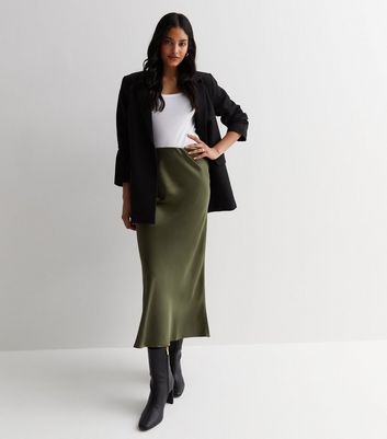 Satin Skirt And Cardigan Outfit, Green Silk Skirt Outfit Winter, Olive Midi Skirt Outfit, Satin Skirt Ideas, Khaki Satin Skirt Outfit, Green Satin Midi Skirt Outfit, Olive Satin Skirt Outfit, Satin Skirt With Boots, Green Silk Skirt Outfit