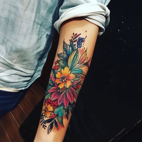 This beautiful forearm tattoo bursts with color and life, featuring a vibrant arrangement of flowers and leaves that create a stunning display of nature's Tattoos On Forearm For Women, Flowers Tattoo Forearm, 3 Bird Tattoos For Women, Tattoos On Forearm, Bird Tattoos For Women, Anatomical Heart Tattoo, Cute Cat Tattoo, Tattoo Forearm, Foot Tattoos For Women