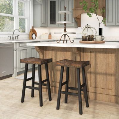 Combining solid wood material and simple appearance as one, these stools can add a natural feeling to any room space. Whether it's at home, in a restaurant, cafe, pub, or any other setting, these stools are the perfect companion. Seat Height: Bar Stool (29" Seat Height) | 17 Stories Solid Wood Saddle-Seat w / Curved Seat Surface & Comfortable Footrests black / Wood in Brown | Bar Stool (29" Seat Height) | Wayfair Farmhouse Kitchen Stools, Country Bar Stools, Saddle Seat Bar Stool, Farmhouse Bar Stools, Rustic Bar Stools, Sitting Space, Black Counter Stools, Natural Wood Kitchen, Kitchen Island Bench