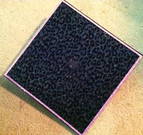 Half way finished with my grad cap! Black leopard print with glitter pink borders. Alt Graduation Cap, Emo Graduation Cap, Rhinestone Graduation Cap, Grad Hats, Graduation Hats, The Cheetah Girls, College Graduation Cap Decoration, Grad Hat, School Boxes