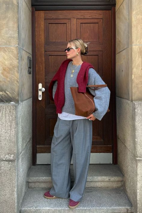 @linda.sza wears the Sézane Amiel Jumper in grey, a long-sleeved baby alpaca knit with a slightly oversized fit. She styles it with a burgundy cardigan tied over the shoulders, grey trousers, and the Sézane Gabin suede tote bag. Check out our latest arrivals at sezane.com or via the app. Jumper Tied Around Shoulders, Suede Sneakers Outfit, Burgundy Sneakers Outfit, Jumper Outfit Women, Grey Jumper Outfit, Pantsuit Outfit, Burgundy Shoes Outfit, Linda Sza, Chilly Weather Outfits