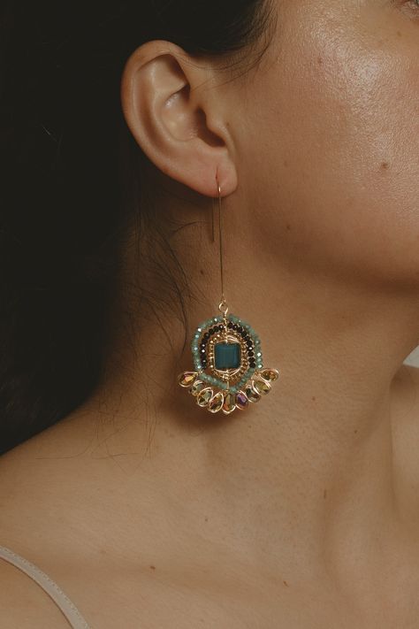 Make a statement with these beautiful handmade Estela Drop Earrings! The elegant, intricate design adds a special touch, and the colorful designs will be sure to stand out at any event. The intricate design adds a unique sophistication, while the dazzling colors will be sure to turn heads - the perfect accessory for any occasion. Details Size: 2.75" H x 1.25" W Elaboration Time: 2.5 hours Material: Faceted crystals Metal: gold plated, hypoallergenic, nickel free Technique: Herringbone technique Please Note: Each pair is made by hand and therefore one-of-a-kind.Care Instructions: This item should be kept in a dry space when not wearing. Statement Earrings Colorful, Colorful Wedding Jewelry, Ornate Festive Earrings With Intricate Design, Traditional Earrings With Intricate Design, Traditional Intricate Drop Earrings, Elegant Ceremonial Earrings With Motifs, Ceremonial Earrings With Intricate Design, Vintage Indian Jewelry, The Dazzling