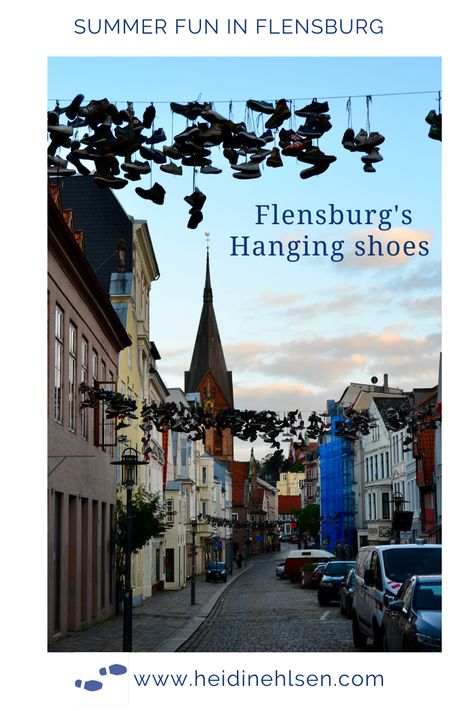 There are hundreds of shoes hanging on wires strung between the house gables in the old town of Flensburg, Germany. Click to find out why. Flensburg Germany, Shoes Hanging, Germany Berlin, Cities In Germany, Hanging Shoes, Old Cemeteries, Maritime Museum, Sailing Yacht, Wooden Boats