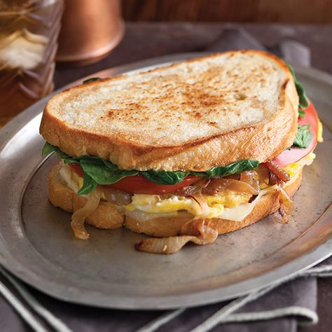 This simple Egg and Caramelized Onion Sandwiches is a delightful stack of Swiss cheese, sweet onions, spinach, tomatoes, and mayonnaise on sourdough bread. Sourdough Bread Sandwich, Onion Sandwich, Cheese And Onion Sandwich Filling, Sourdough Egg Sandwich, Cheese And Onion Sandwich, Sourdough Breakfast Sandwich, Egg And Onion Sandwich, Onion Eggs Breakfast, Egg Sandwich