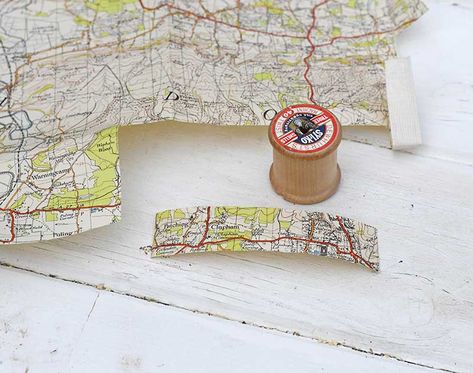 Have you noticed that most old road maps are printed in festive colours. That is the roads are often printed in red and rural areas in green all on a white background. This makes them perfect for Christmas crafting in the past I have made some wonderful upcycled road map decorations for my home (see here). This time I decided to use the maps to make a unique and personalized map ornament for the tree.     I used old out of date road maps and some cotton reels for this Christmas craft.… Map Ornaments Diy, Map Decorations, Craft Bells, Craft Cupboard, Road Maps, Map Ornaments, Favorite Christmas Songs, Popular Christmas Gifts, Christmas Crafting