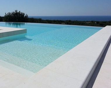 capri white limestone bulnose poo coping tiles and pavers, white pavers, outdoor pavers by stone pavers Bullnose Coping Around Pool, Pool Limestone Pavers, White Swimming Pool Tiles, White Tiled Pool, Outdoor Pool Tiles, White Pool Area, Limestone Pool Paving, Limestone Pool Coping, White Tile Pool