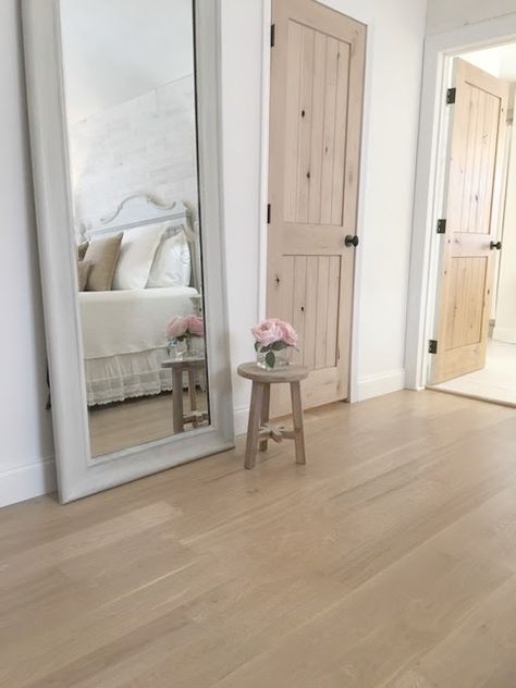 My master bedroom with white oak hardwood flooring and rustic alder doors - Hello Lovely Studio. Romantic Bedroom Lighting, Alder Doors, Knotty Alder Doors, Cottage Style Furniture, White Oak Flooring, Bedroom Details, Stained Doors, White Bedroom Decor, French Country Bedrooms