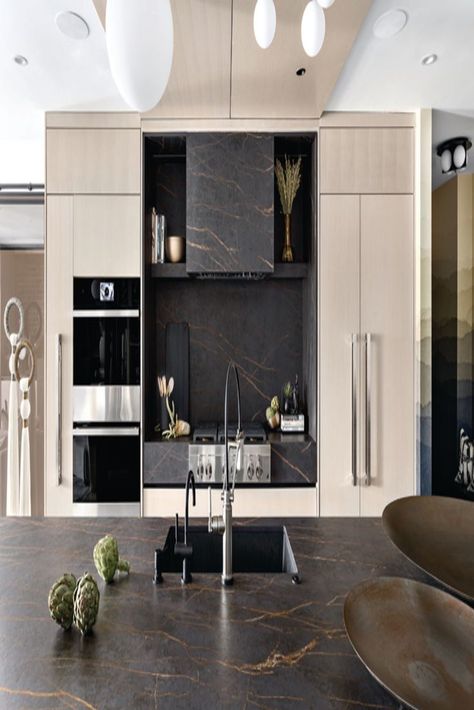 When Aleem Kassam, principal of Kalu Interiors, designed the sleek kitchen in his own downtown Vancouver condo, he fell head-over-heels with a bronze-veined, dark brown stone (specifically, Cosentino’s Dekton Laurent). He was all in. “When you have a material that works well in a space, why not try to take it to the next level?” says Kassam. Dekton Laurent, Dark Brown Kitchen, Vancouver Condo, 2022 Kitchen, Miller Homes, Sleek Kitchen, Brown Kitchens, Integrated Appliances, Fashion Organization