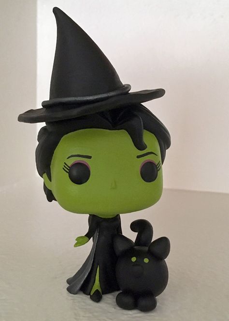 Completed 07/2019! Elphaba from Wicked is my newest custom Funko Pop (honestly, I've never read the book, but I love the idea of the "true" story of the Wicked Witch of the West and, well, she's adorable :D) It was my first attempt at creating accessories from modeling clay. The Wicked Witch Of The West, Wicked Witch Of The West, Custom Funko Pop, Witch Of The West, Custom Funko, Disney Fairy, Pinterest Projects, Modeling Clay, Vinyl Dolls