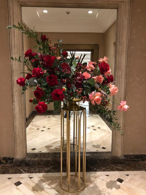 Floral Podium Arrangement, Red And Green Centerpieces, Red And Gold Floral Arrangements, Tall Floral Arrangements, Red Centerpieces, Flower Backdrop Wedding, Green Centerpieces, Red Orchids, Large Flower Arrangements