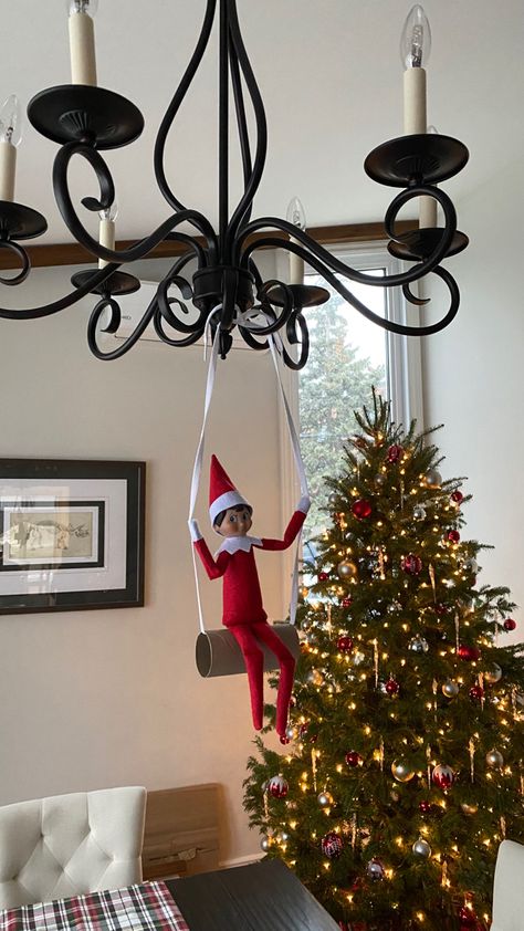 Elf on the shelf is swinging on a toilet paper roll hanging from a chandelier. Jennifer Garner, Toilet Paper Roll, Holiday Trends, Paper Roll, Fun Ideas, On The Shelf, Design Tips, Elf On The Shelf, Holiday Fun