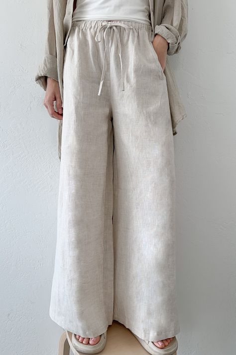 The Island Time Wide Leg Linen Pants in Natural are a dream pair of summer pants! The natural fabric and lightweight feel make them ready for your next summer vacation! Featuring an elastic waistband, linen fabric, wide legs, pocket, natural color, oversized fit and a lightweight feel. Style these linen pants with an effortless tank top and sandals! Details & Sizing Elastic waistband Linen fabric Wide leg Pockets Natural color Oversized fit Lightweight feel Gabriella is wearing a size S Fabric 1 Straight Leg Cotton Pants, Linen Summer Pants, Cream Linen Pants, Summer Linen Pants, Midi Jumpsuit, Linen Pants Outfit, Short Coats, Short Coats Women, Linen Bottoms