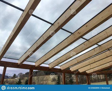 Photo about The detail of the transparent glass roof of the wooden pergola by the modern house. Image of tempered, beam, wooden - 225660899 Wooden Beam, House Image, Wooden Pergola, The Modern House, Pergola With Roof, Pergola Kits, Glass Roof, Wooden Beams, Backyard Patio