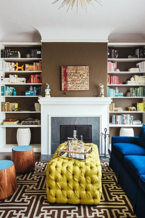 To create a sitting room that's fresh and full of visual interest, designer Noz Nozawa used brown walls as a backdrop for saturated blue and gold furniture. Books organized by color draw the eye from floor to ceiling. Family House Living Room, Fireplace Bookshelves, Floating Shelf Decor, Floating Bookshelves, House Living Room, White Fireplace, Bookshelf Design, Eclectic Living Room, Chic Spaces