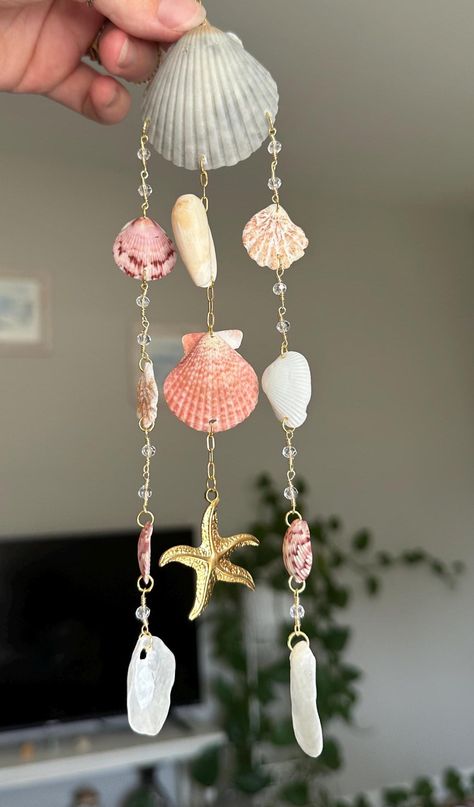 All shells are handpicked from various beautiful beaches in Florida, then cleaned, sanitized, polished, and drilled in preparation to become a jewelry piece or decoration. Did you know that no two shells are the same? Every shell is as unique as a fingerprint, guaranteeing that your piece is one-of-a-kind, just like you! Enhance your car's look with our handmade Shell Car Charm. Each piece features authentic shells, bringing a serene coastal touch to your drive. Perfect for ocean lovers! Shell Chimes Diy Seashells, Decoration With Shells, Seashell Car Decor, Diy Shell Jewelry, Shell Suncatcher, Things To Do With Sea Shells, Handmade Dangle Shell For Summer, Shell Cleaning, Sea Shell Mobile Diy