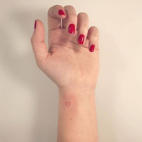 Red ink heart tattoo on the wrist. Love Heart Tattoo On Wrist, Cute Heart Tattoos On Wrist, Red Heart On Wrist Tattoo, Small Red Heart Tattoo On Wrist, Mini Heart Tattoo Wrist, Red Heart Finger Tattoo, Red Love Heart Tattoo, Heart On Wrist Tattoo, Small Heart Tattoo On Wrist