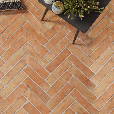 Sold by the m2 Requires sealing Ca' Pietra Marlborough Parquet Terracotta Floor Tile 7.5x30.5cm. Terracotta tiles with a handmade finish. Transform your space into a rich russet oasis of yesteryear with these terracotta parquet floor tiles. Also available as arabesque tiles and hexagon tiles. Terracotta floor tiles Ca' Pietra presents the Marlborough range. With these terracotta tiles, nostalgic red and orange pigments are revisited and redesigned for the modern and hardworking home. Take yourself to terracotta floor tiles heaven with this classic choice, sure to stun as kitchen floor tiles, hallway tiles and living room flooring, while emulating country cottage chic. Brick effect tiles But the rustic tiles appeal doesn't stop there; lay these crafted clay brick beauties in a herringbone t Terracotta Herringbone Floor, Terracotta Terrace Floor, Brick Floor Kitchen Farmhouse Style, Terracotta Herringbone Tile Floor, Terracotta Tiles Living Room, Floor Tiles Hallway, Terracota Tiles Floor Modern, Terracotta Tiles Laundry, Terracotta Bathroom Tiles