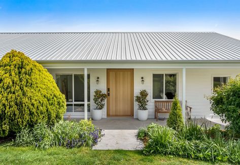 By cladding over her tired brick home, a Tasmanian homeowner has created a Modern Country success story that balances country... Cladding Over Brick: A Country Transformation was published on Mouths of Mums. House Exterior Before And After, Weatherboard House, Brick Projects, Modern Coastal Home, Australia House, Home Transformation, Terrazzo Floors, Brick Exterior House, Brick Home