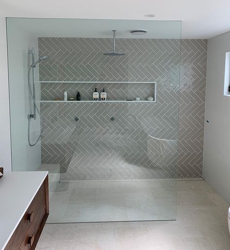 TC Tiling on Instagram: “Herringbone ensuite || Lilli Pilli project: Herringbone feature wall and French pattern travertine on the floor” Shower Feature Wall Ideas, Herringbone Feature Wall Bathroom, Chevron Bathroom Tile Wall, Grey Herringbone Tile Bathroom, Herringbone Backsplash Bathroom, Chevron Bathroom Tile, Herringbone Bathroom Wall, Chevron Tile Bathroom, Herringbone Feature Wall