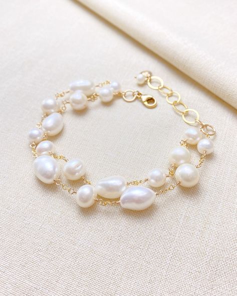 Make a classic and elegant statement with this multi-layered mixed pearl bracelet. Two handcrafted strands of differently shaped and sized pearls create a versatile accessory suitable for weddings, brunches, work, and more. The lobster clasp and extender ensure a secure and adjustable fit. Length: 7.5 inches plus 1.5 inch extender Materials: gold fill, cultured freshwater pearls Gift box included. Bracelet Clasps Ideas, Pearl Bracelet Gold, Pearl Gifts, Pearls Diy, The Lobster, Silver Jewelry Necklace, Freshwater Pearl Bracelet, Freshwater Cultured Pearls, Bracelet Clasps