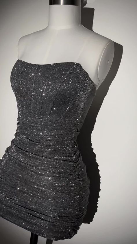 The Blair Glitter Lurex Mini Dress is your must have for party season. Featuring a structured corset design with added boning to give you a cinched in silhouette and extra ruched detailing for the most stunning figure-hugging fit. The Dark Grey corset dress is the perfect mini for your birthday outfit and will ensure all eyes are on you. Pair with sparkly heels and matching silver jewellery for the most perfect fit. Zip fastening Corset design Boning detail Strapless Dark Grey glitter fabric Our Stary Night Hoco Dress, Silver Dress Ideas, Dress Hoco Short, Birthday Black Dresses, Gray Hoco Dresses, Euphoria Homecoming Dress, Silver Dress Homecoming, Diamond Homecoming Dress, Corset Homecoming Dress Short