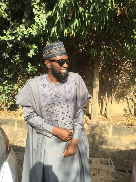 A Northern Nigerian outfit called Babban Riga or Malun-Malun in Hausa language. It is also called Agbada in Yoruba and Otogbo in Igala language. Babban Riga, Hausa Language, Nigerian Outfits, Riga, Ray Bans