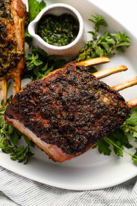 This roasted rack of lamb is coated with a blend of fresh herbs and then roasted to perfection. The result is a delicate crust on the outside, with a tender and juicy inside. Served alongside a vibrant mint chimichurri, this dish lets the natural flavors of the lamb take center stage so you can savor every bite. #theendlessmeal #lamb #rackoflamb #roastedlamb #roastedrackoflamb #dinner Rack Of Lamb Recipes, Mint Chimichurri, Roasted Rack Of Lamb, Roast Rack Of Lamb, Lamb Chop Recipes, Single Serving Recipes, Rack Of Lamb, The Lamb, Lamb Recipes