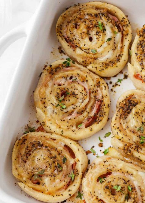 Crispy rolls filled with melty cheese, and savory ham, brushed with a Dijon glaze and topped with poppy seeds are what make these baked ham and cheese pinwheels so tasty! A popular appetizer or snack made in under 30 minutes! Fancy Appetizer Recipes, Crispy Rolls, Ham And Cheese Pinwheels, Savory Ham, Pinwheel Sandwiches, Pin Wheels, Ham And Swiss, Cheese Pinwheels, Pastry Appetizer