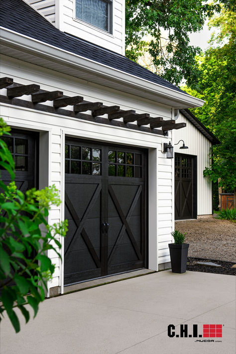 black overlay garage doors with windows on white modern farmhouse home Farmhouse Garage Doors, Garage Doors Black, Beautiful Beach Houses, Farmhouse Garage, Black Farmhouse, Dream Beach Houses, Overhead Door, House Paint Exterior, Oak Color