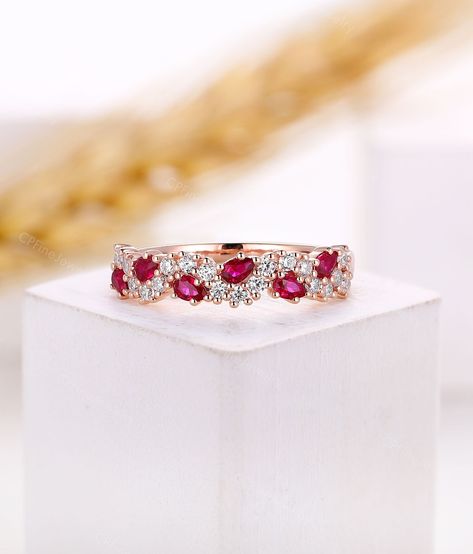 *Design inspiration* Cluster rings often receive plenty of attention. Featuring smaller diamonds placed next to each other, they can be designed to form various shapes that come up to your mind. And the smaller stones compliment each other and offer extra sparkle. This collection makes themselves a popular choice for those seeking u unique design. Ring Information Item: Natural Ruby Wedding Band Metal: 14k/18k solid gold, Platinum 950 Wedding Band ▲Center Stone:Natural Ruby Shape: Pear Shaped  S Elegant Ruby And Diamond Half Eternity Ring, Fine Jewelry Cubic Zirconia Ruby Ring For Wedding, Anniversary Ruby Ring With Halo Design In Cubic Zirconia, Wedding Ruby Ring With Diamond Cut Cubic Zirconia, Elegant Half Eternity Rings With Lab-created Ruby, Wedding Ruby Ring With Halo Design And Cubic Zirconia, Ruby Ring With Cubic Zirconia Halo Design For Wedding, Fine Jewelry Lab-created Ruby Diamond Ring With Halo Design, Fine Jewelry Diamond Ruby Half Eternity Ring