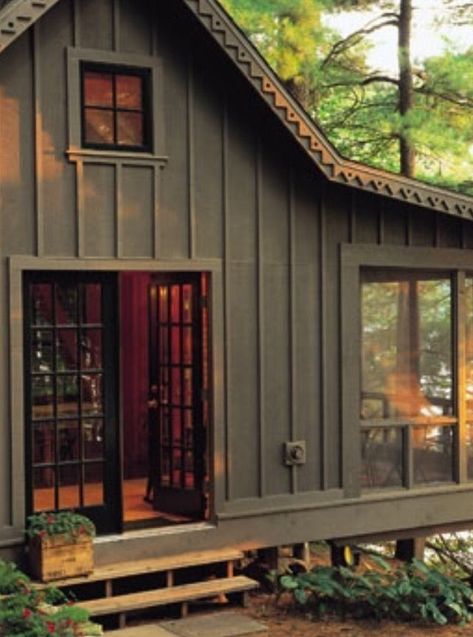 Dark Green Cabins, Dark Green Mountain Home Exterior, Verticle Siding Exterior Ranch, Dark Exterior Cabin, Painted Cabin Exterior, Dark Brown Cabin Exterior, Dark Green And Cedar House Exterior, Woodsy Exterior House Colors, Cabin Paint Exterior