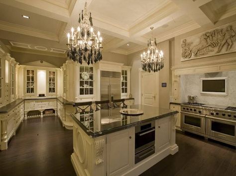 Spacious white kitchen with dark flooring and countertops. Custom cabinetry throughout providing a great deal of storage. Hiasan Dalaman Dapur, Dapur Moden, Luxurious Kitchen Design, Royal Kitchen, Homes Inside, Victorian Kitchen, Kitchens Luxury, Large Kitchen Island, Dream Kitchens Design