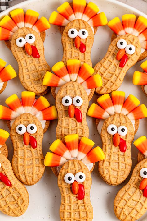 Nutter Butter Turkeys are a fun and festive no-bake treat that's perfect for Thanksgiving celebrations. These adorable cookie creations use classic Nutter Butter cookies, candy corn, and chocolate to make cute turkey shapes that kids and adults alike will love. Ideal for holiday parties, classroom treats, or a fun kitchen project with the family, these easy-to-make Nutter Butter Turkeys add a playful touch to your dessert spread. Enjoy the sweet and whimsical charm of these turkey-themed treats that bring the holiday spirit to life! Butter Turkey, Peanut Butter Sandwich Cookies, Candy Wafers, Thanksgiving Desserts Table, Turkey Treats, Turkey Cookies, Candy Eyeballs, Nutter Butter Cookies, Dessert Spread