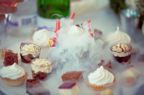 Cupcake display among billowing dry ice Dry Ice Party Ideas, Dry Ice Dessert Table, Ice Table, Futuristic Party, Ice Dessert, Descendants Party, Ice Show, Cupcake Display, Dry Ice