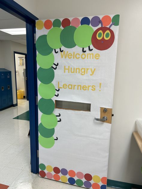 Welcome Sign Front Door For Preschool, Caterpillar Door Decorations Classroom, Hungry Caterpillar Bulletin Board Ideas, Hungry Caterpillar Bulletin Board, Daycare Door Ideas, Hungry Caterpillar Classroom, Daycare Bulletin Boards, Speech Classroom, Caterpillar Activities