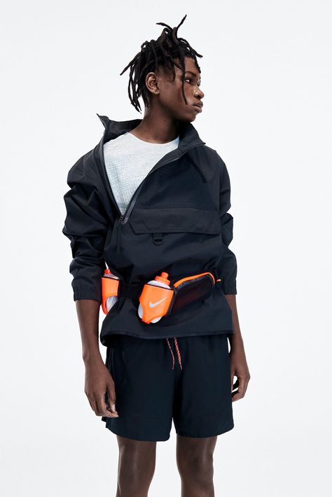 Waist-up image of man highlighting Nike jacket and accessories, second frame shows full image of man, highlighting the full outfit, including shorts, jacket, shirt, and accessories. Breathable Nylon Techwear Windbreaker, Outdoor Techwear Windbreaker With Zip Cuffs, Techwear Long Sleeve Sports Parka, Urban Adventure Techwear Windbreaker, Long Sleeve Gore-tex Techwear Windbreaker, Sporty Aesthetic, Nike Tech, Branding Photos, Open Up